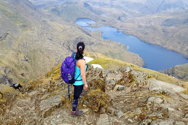 Person hiking up the side of a steep mountain.