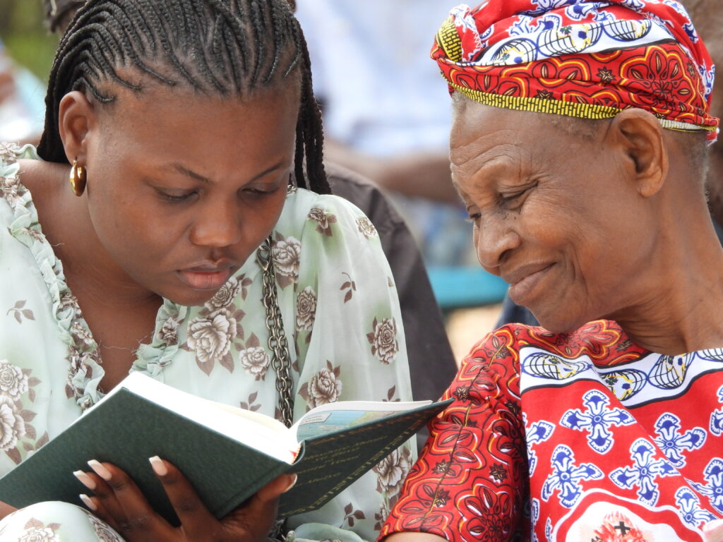 Two Rangi women reading the Bible.