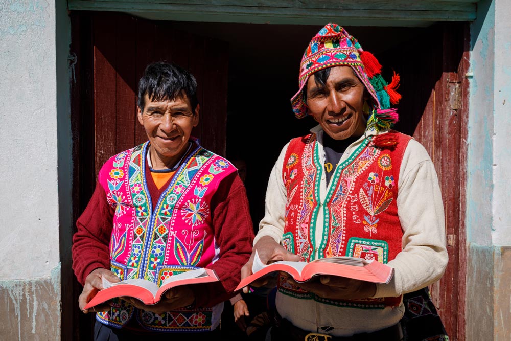 Two men in the Americas holding Bibles