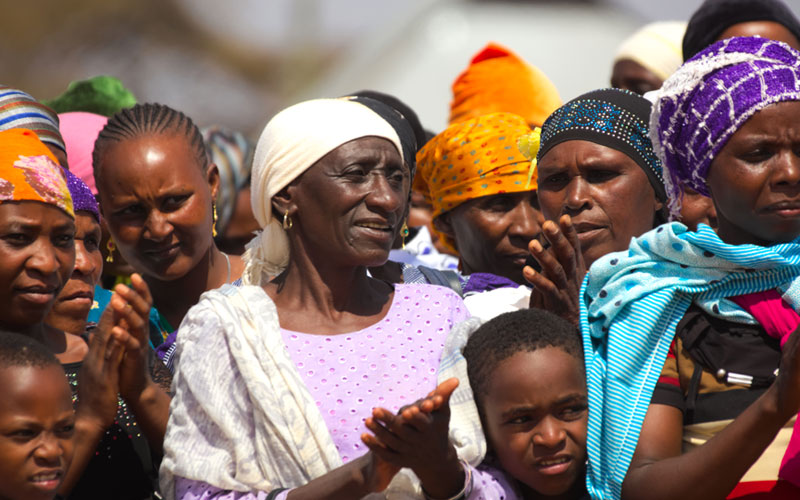 Woman clapping at New Testament dedication for the Burunge.