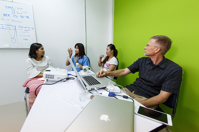 Mark Penner working as a consultant with three other people.