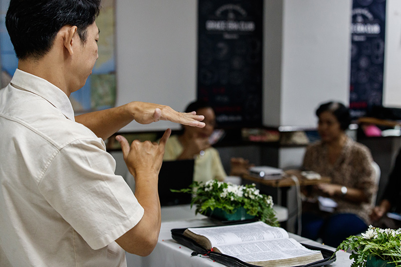 Pastor Montri preaching to his congregation.