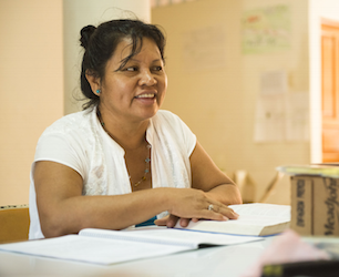 Woman smiling at desk.
