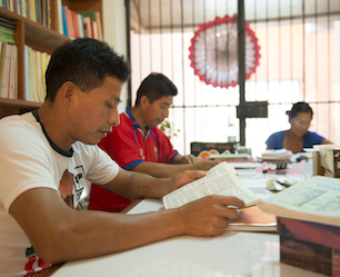 Three translators working at a table.
