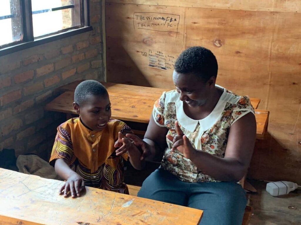 A woman and child use Rwandan Sign Language.