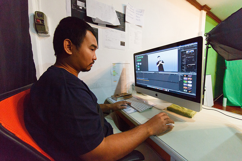 Tum, a video editor at computer.