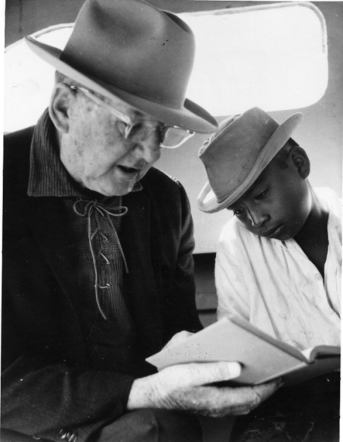 Uncle Cam reads the Bible with a young boy Uncle Cam reads the Bible with a young boy