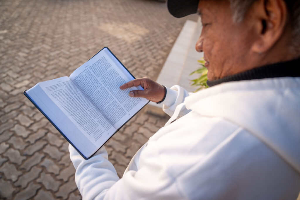 Man reading the Sihanaka Bible.