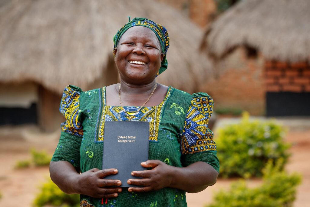 Woman from Uganda holding Bible.