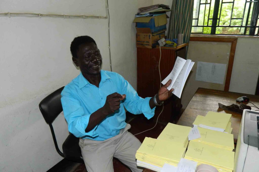 July 2013: Translator and pastor Enos Dada sings from a Keliko song book.