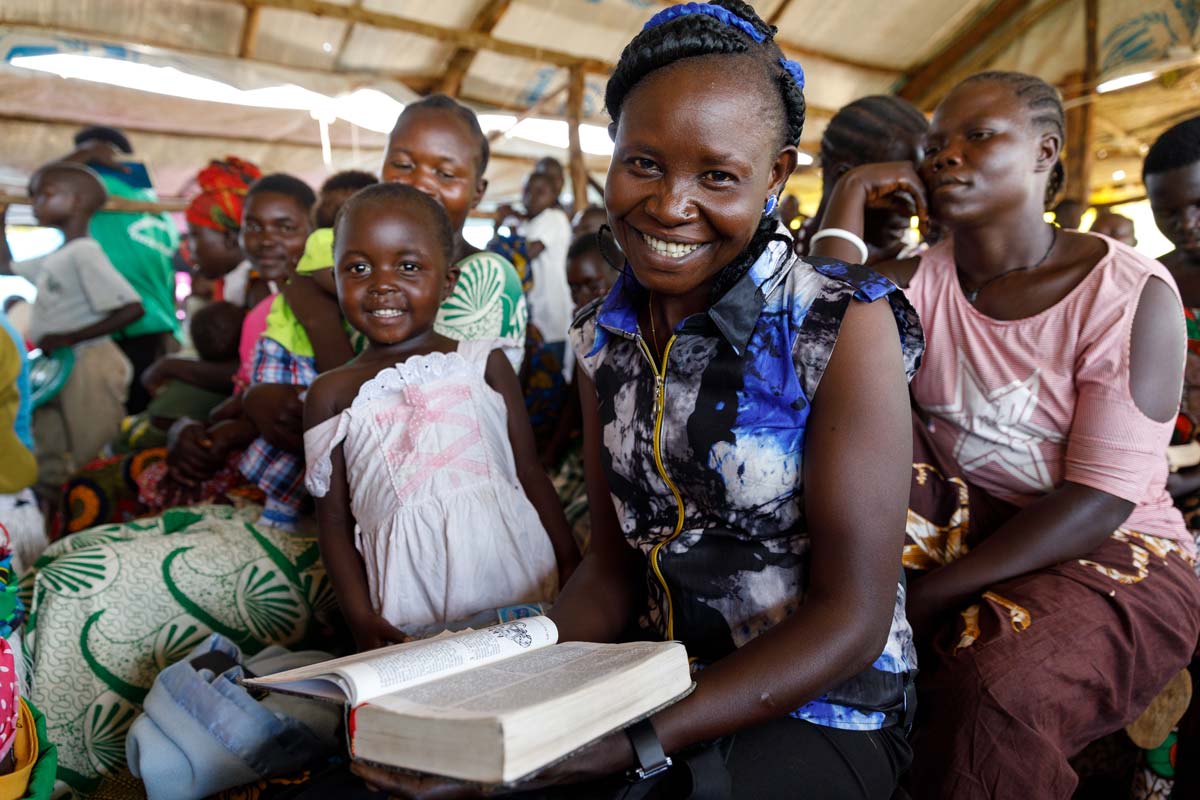 Keliko woman holding her Bible and smiling.