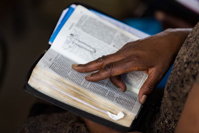Hand on open Bible.