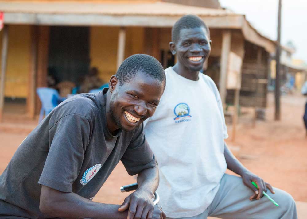 Two laughing men in the village.