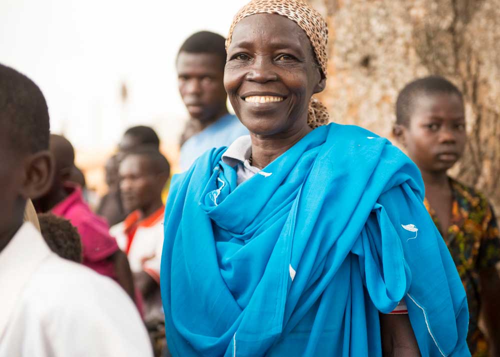 Woman smiling with a group around her.
