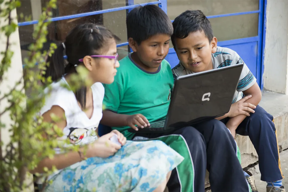 Three kids on a laptop