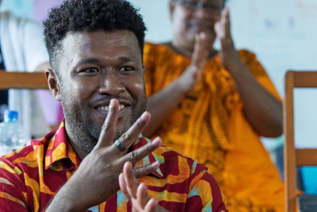 Man from Fiji signing and smiling.