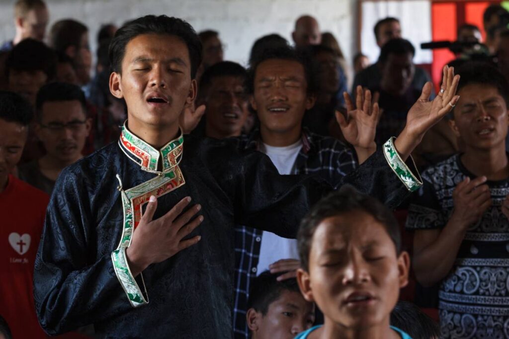 Man worshipping with church congregation.