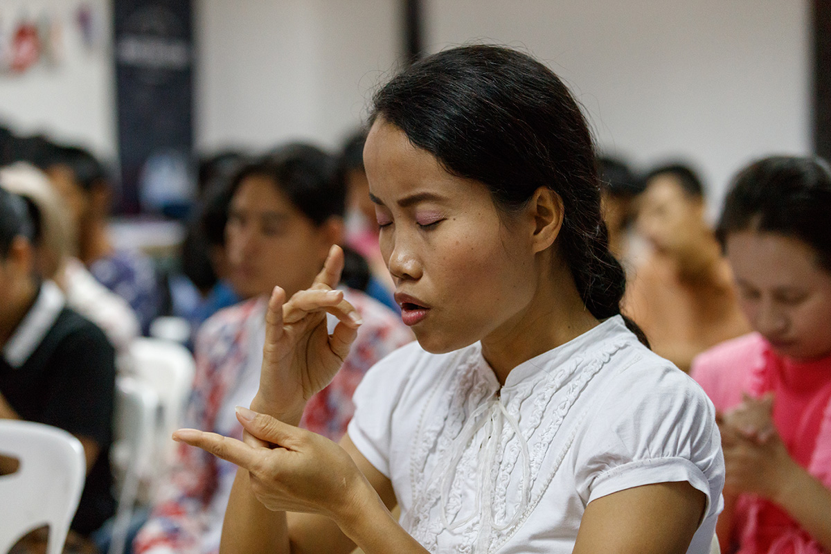 Woman from Thailand using sign language.